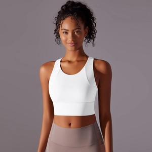 Detail of white sports bra with wide straps and elastic hem for yoga and fitness training