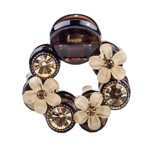 Elegant camellia flower hair claw with brown resin, matte petals and shiny rhinestones