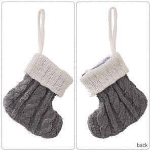 Detailed views of grey cable knit Christmas stocking with white ribbed cuff and hanging loop