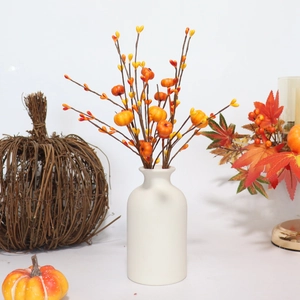 DIY berry pumpkin branch in white ceramic vase for Halloween and Thanksgiving decor