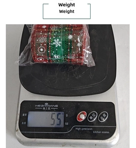 Detailed view of Christmas snowflake plaid ribbon on a scale showing 55g weight