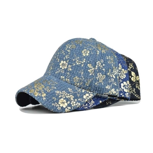 Detail of high-quality cotton baseball caps with gold floral print in three colors