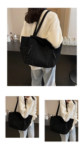 Dettaglio della borsa tote in velluto a coste nero con texture a righe e tasca laterale