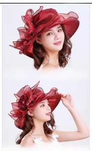 Detail of wide brim burgundy organza sun hat with floral decor and wavy edges