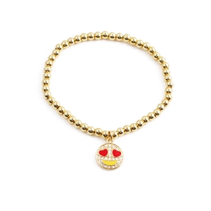 Golden beaded stretch bracelet featuring a sparkling diamond heart-eye smiley face charm