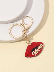 Detailed view of a gold-tone key chain with a red enamel lip pendant featuring Mom lettering