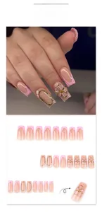 Detail of 3D gold-edged flower and pink French tips on long ballerina press-on nails