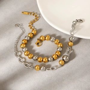 Bracelet en perles d'acier inoxydable bicolore or et argent avec fermoir mousqueton