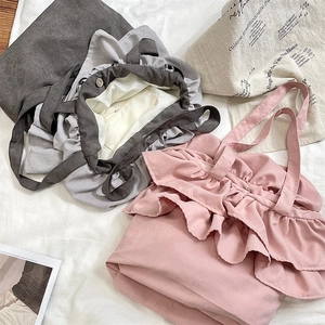 Detailed interior of ruffle tote bag showing magnetic closure and inner zipper pocket