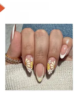 Detail of almond-shaped press-on nails with yellow daisies and bow art designs