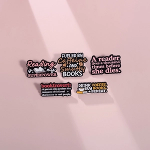 5-piece metal enamel pin set featuring book themes and caffeine quotes on pink background
