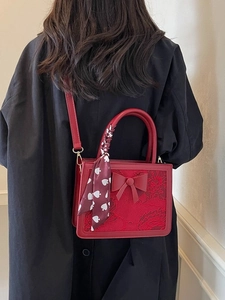 Red wedding handbag with floral embroidery, bow decor and scarf-wrapped handle