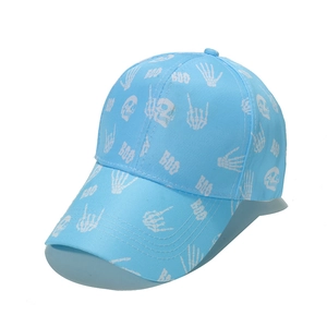 Detail of light blue baseball cap featuring white skull and BOO street style prints