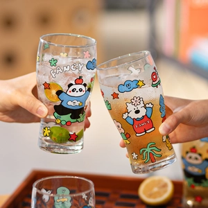 Pair of large cartoon glass beer mugs with fancy patterns and lemon slices inside