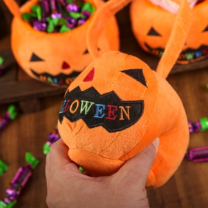 Close-up of soft plush orange pumpkin candy bag showing premium texture and embroidery