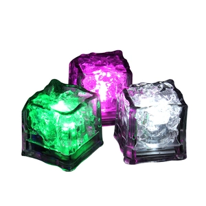 Water-activated LED glowing ice cubes in green, purple, and white with crystal texture