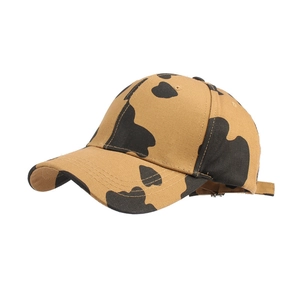 Khaki cow print baseball cap with curved brim and adjustable strap for outdoor wear