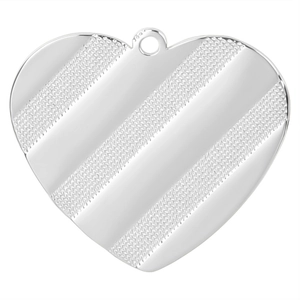 Macro shot of silver heart pendant with striped texture and polished metal finish