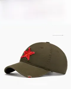 Detail of army green baseball cap with red star embroidery and distressed brim texture