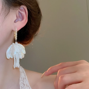 Detail of floral petal drop earrings with pearl tassels and gold metal fasteners