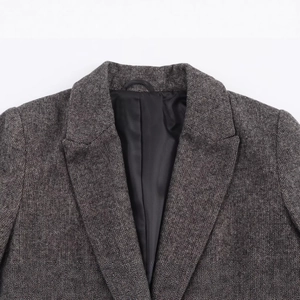 High-quality herringbone wool blazer featuring notched lapels and smooth inner lining