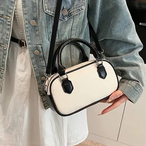 Two-tone woven canvas Boston bag with black leather trim and crossbody strap for women