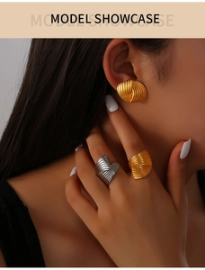 Detail of 18K gold and silver plated textured wavy rings and matching earring set