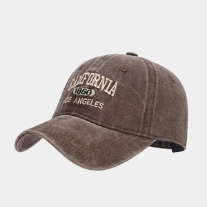 Detailed view of the vintage embroidered lettering and washed cotton fabric texture