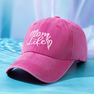 Close-up of pink washed cotton baseball cap with Mom Life embroidery on blue water background