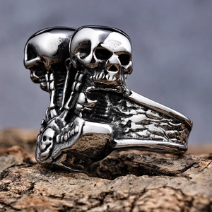 Gothic silver stainless steel double skull ring for men on rustic wood background