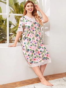 Detail of V-neck lace trim on pink floral short sleeve nightgown with tropical print