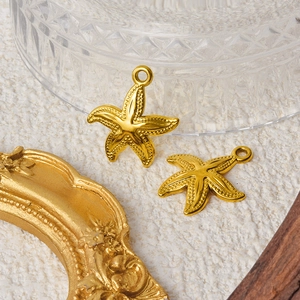 Two golden stainless steel starfish pendants with detailed textures for DIY jewelry making