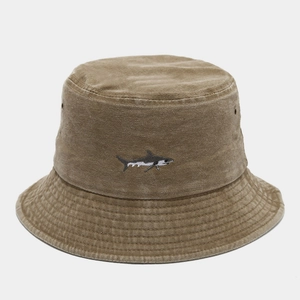 Detailed close-up of shark embroidery on a vintage washed khaki cotton bucket hat