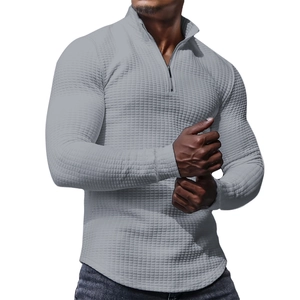 Close-up of grey waffle knit fabric texture on men's half-zip stand collar sweatshirt