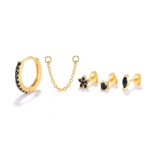 Detail view of 5-piece gold S925 silver earring set with black zircon stones