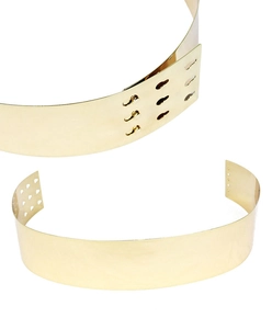 Detail of adjustable golden mirror metal belt with multi-hole buckle for women dresses