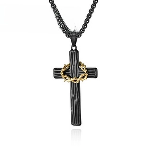 Detail of black metal cross pendant with golden thorn crown and round link chain