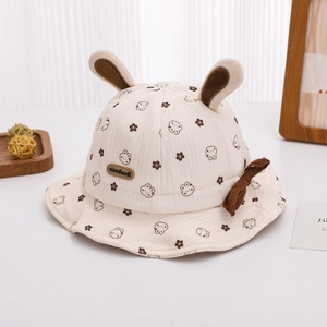Detail of baby sun hat featuring 3D rabbit ears, cute bear prints, and a leather logo tag