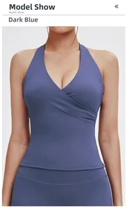 Detail of teal blue sports bra with deep V-neck, halter design and ruched crossover front
