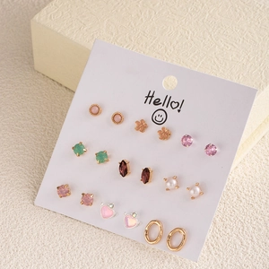 Macro shot of a 9-pair earring set featuring crystal, pearl and gold geometric designs