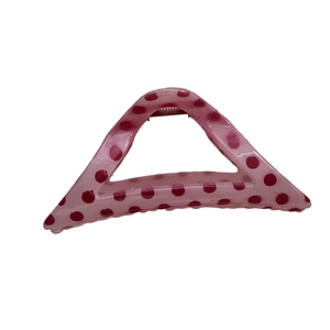 Pink hair claw clip with red polka dots for women's hairstyling on white background