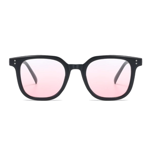 Oversized black frame sunglasses with pink lenses for a slimming facial effect