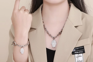 Detail of silver Hamsa Hand necklace and bracelet set with OT toggle clasp on model