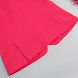 Detail of rose red blazer hem showing smooth fabric texture and precise stitching