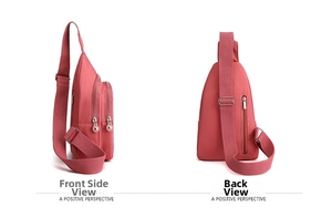Detail view of pink nylon crossbody bag showing side and back layers with zippers