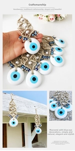 Detail of handmade evil eye macrame wall hanging with blue beads and jute rope