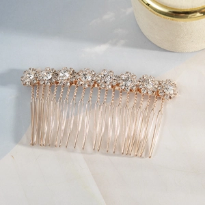 Elegant gold bridal hair comb featuring eight rhinestone sun-flower motifs on light background