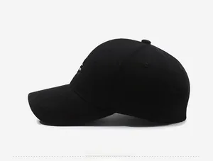 Side view of black cotton baseball cap with small white embroidery detail on the panel