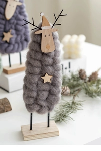 Detail of wool felt Christmas reindeer with wooden base and star decoration