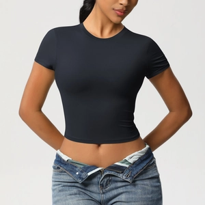 Close-up of a black slim-fit cropped sports T-shirt with a crew neck and elastic fabric